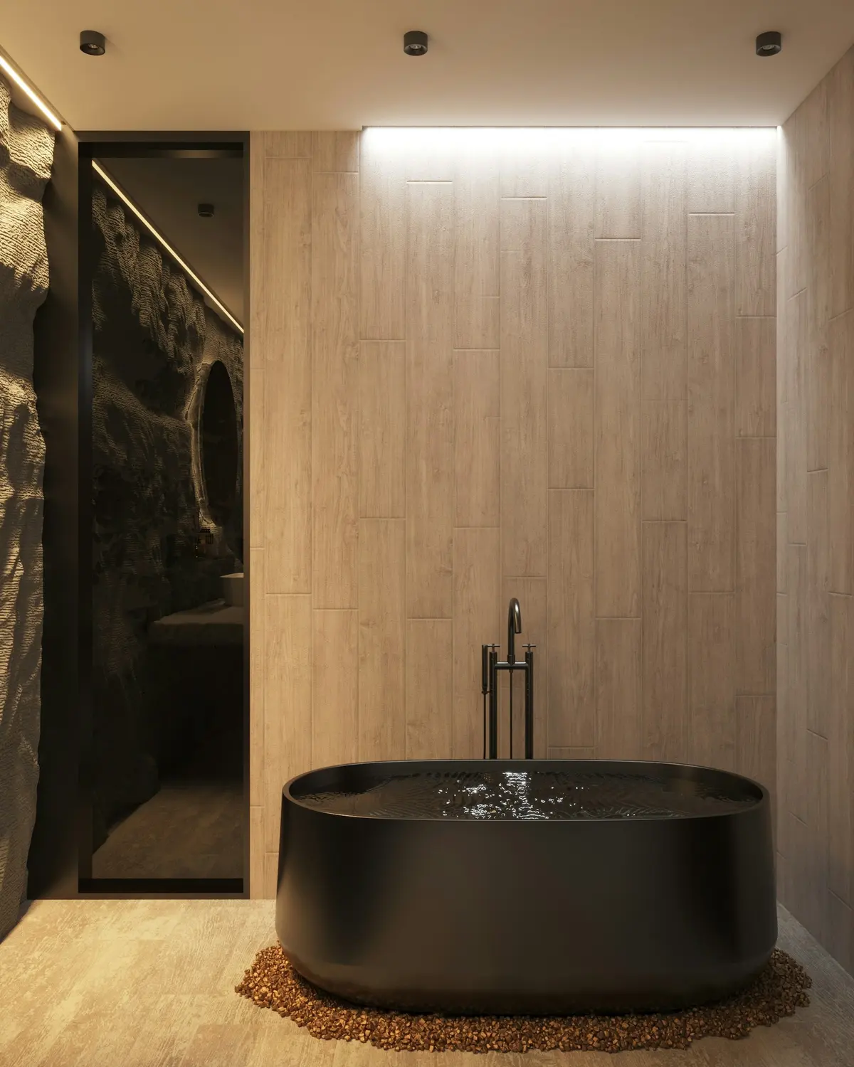 Freestanding stone bath beside a rough stone wall